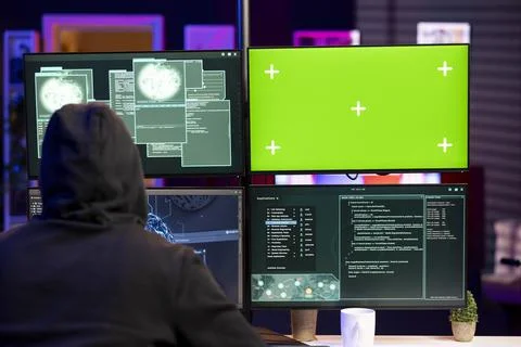 Hacker doing phishing attacks using green screen PC, tricking users Stock Photos