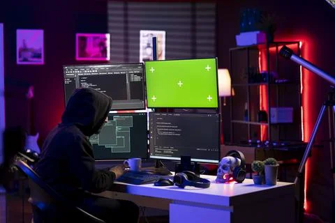 Hacker doing ransomware attacks using green screen PC Stock Photos