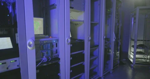 Hacker enters server room and starts to type code Stock Footage 107341240