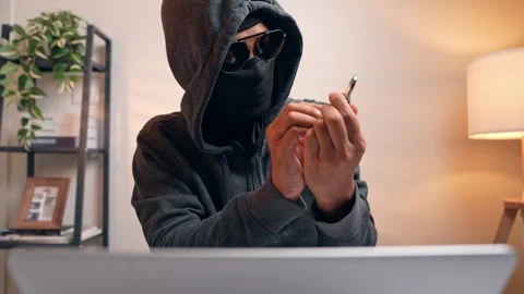 A hacker examines a combination lock. Stock Footage 316567839