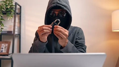 A hacker examines a padlock. Stock Footage 316567838