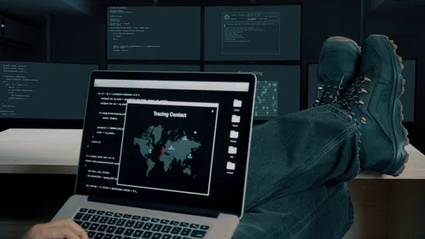 Hacker feet up to table. Hacker with laptop coding exploit to crack code Video stock 82911314