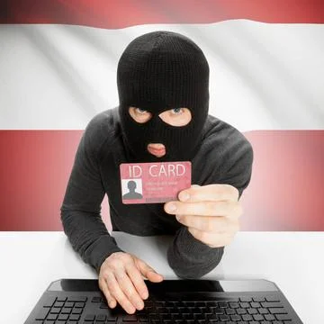 Hacker with flag on background holding ID card in hand - Austria Hacker wi... Stock Photos