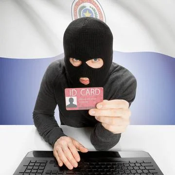 Hacker with flag on background holding ID card in hand - Paraguay Hacker w... Stock Photos