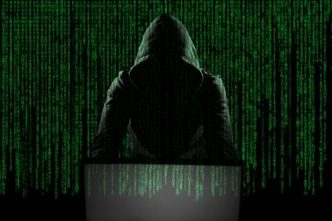 Hacker in front of his computer. Dark face Stock Photos
