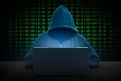 Hacker in front of his computer. Dark face. Stock Photos