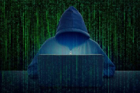 Hacker in front of his computer. Dark face. Stock Photos