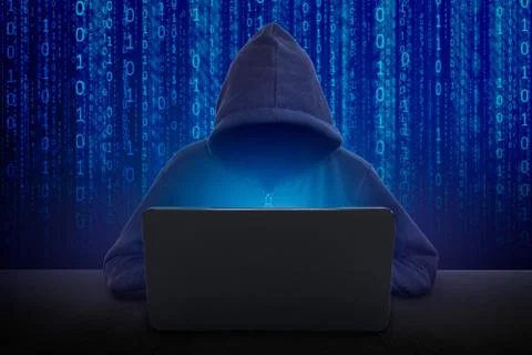 Hacker in front of his computer. Dark face. Stock Photos