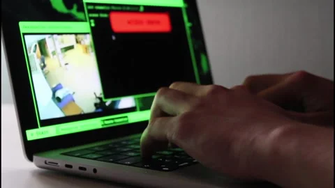 Hacker gaining access to a remote server while monitoring location on a CCTV Stock Footage 201335117