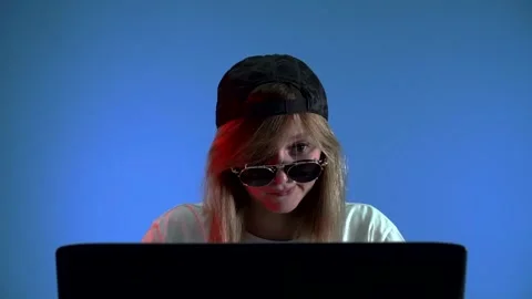 Hacker girl with glasses typing something and chewing gum Stock Footage 142375355