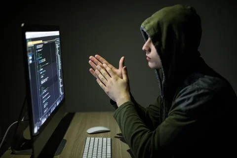Hacker in glasses breaking code. Criminal hacker penetrating network system f 스톡 사진