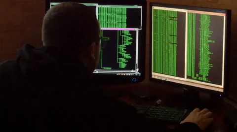 Hacker in glasses breaking code. Rear view Stock Footage 63088788