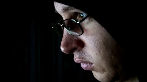 A hacker with the glasses tries to hack the security system on the computer Stock-Footage 77166672