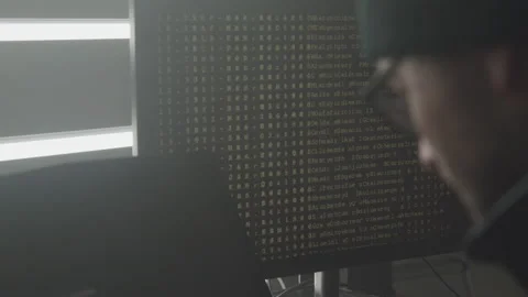 Hacker in Glasses Typing on His Laptop Keyboard in His Basement Stock Footage 208727141