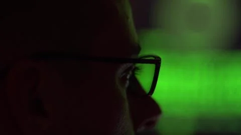 Hacker in glasses working on a computer Stock Photos