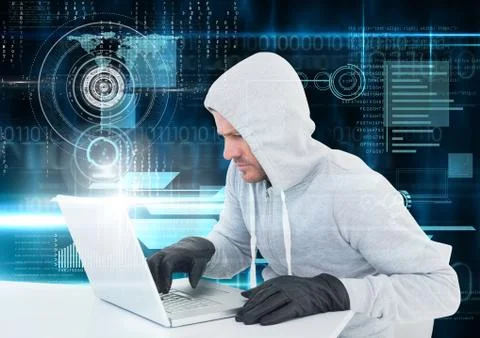 Hacker with glove using a laptop in front of digital background Foto stock