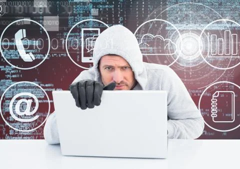 Hacker with gloves using a laptop in front of digital background 写真素材