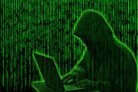Hacker on green digital background 库存照片