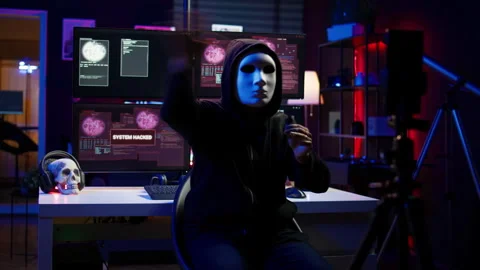 Hacker group member wearing anonymous mask filming video threatening government Stock Footage 275865119