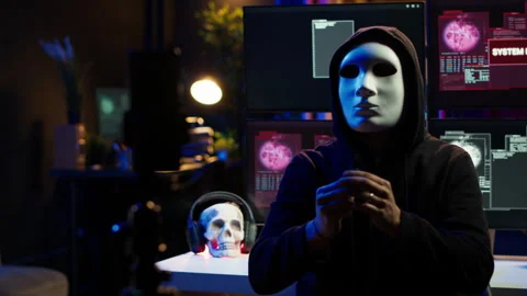 Hacker group member wearing anonymous mask filming video threatening government Stock Footage 275865358
