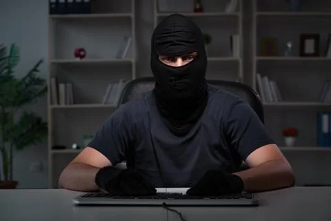 Hacker hacking computer late at night Stock Photos