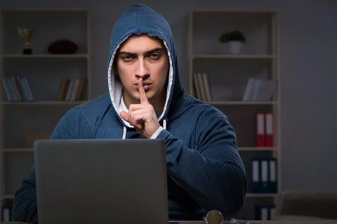Hacker hacking the data late at night Stock Photos