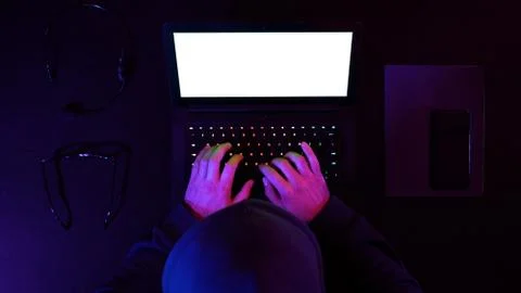 Hacker hacking system on a laptop. White Display. Stock Photos