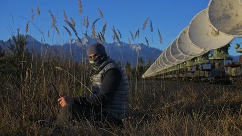 Hacker hacks the radio telescope using notebook. Man to program hacking on Stock Footage 99742458