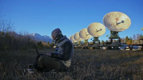 Hacker hacks the radio telescope using notebook. Man to program hacking on Video stock 120719310