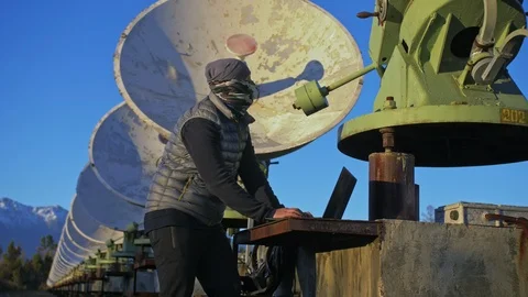 Hacker hacks the radio telescope using notebook. Man to program hacking on Stock Footage 120719422