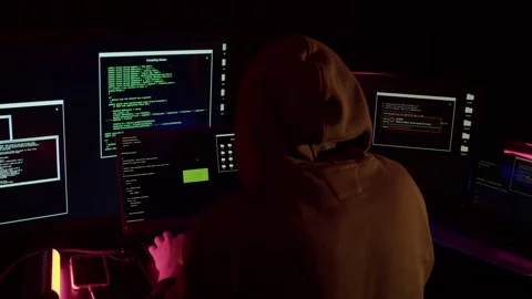A hacker hacks a website against the backdrop of police flashing lights Stock Footage 194783659