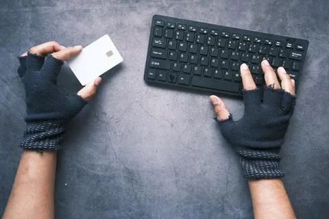 Hacker hand stealing data from credit card Stock Photos