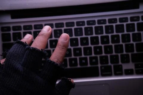 Hacker hand stealing data from laptop, close up Stock Photos