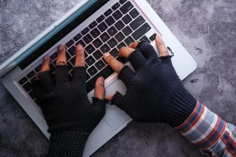 Hacker hand stealing data from laptop at night Stock Photos