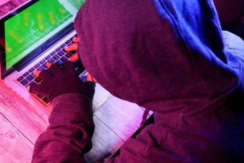 Hacker hand stealing data from laptop top down Stock Photos