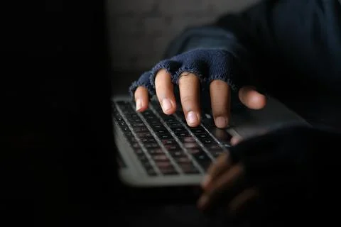 Hacker hand stealing data from laptop top down Stock Photos
