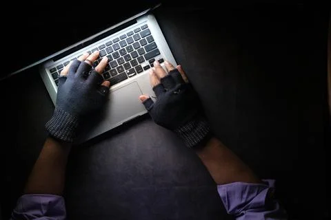 Hacker hand stealing data from laptop top down Stock Photos