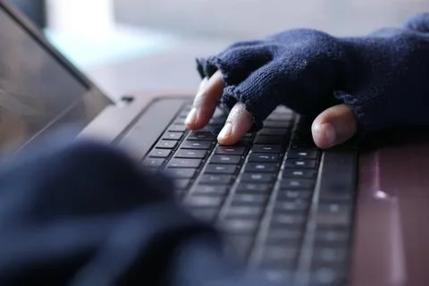 Hacker hand stealing data from laptop top down Stock Photos