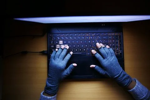 Hacker hand stealing data from laptop top down Stock Photos