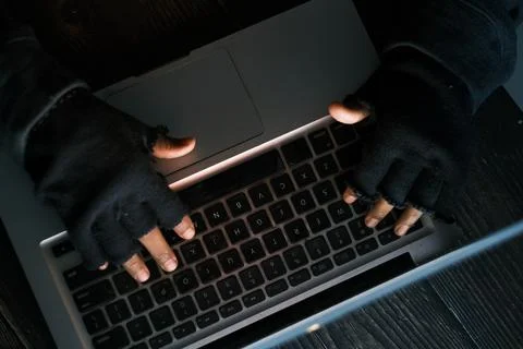 Hacker hand stealing data from laptop top down Stock Photos