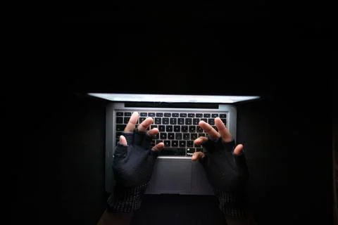 Hacker hand stealing data from laptop top down Stock Photos
