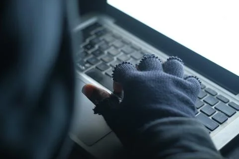 Hacker hand stealing data from laptop top down Stock Photos