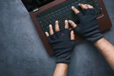 Hacker hand stealing data from laptop top down Stock Photos