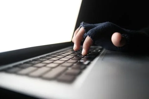 Hacker hand stealing data from laptop top down Stock Photos