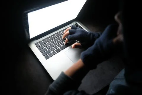 Hacker hand stealing data from laptop top down Stock Photos