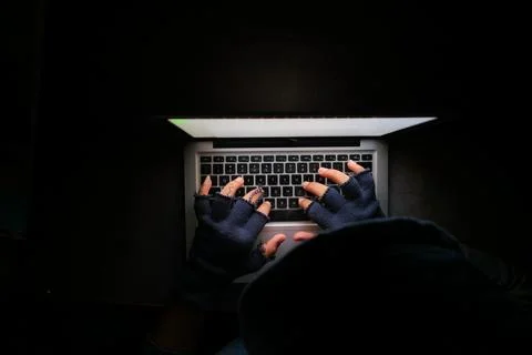 Hacker hand stealing data from laptop top down Stock Photos