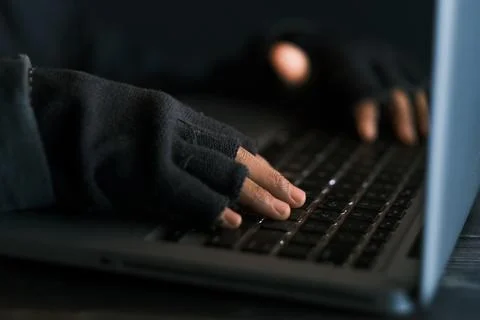 Hacker hand stealing data from laptop top down Stock Photos