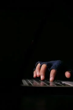 Hacker hand stealing data from laptop top down Stock Photos