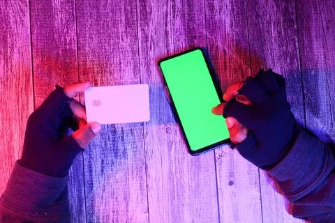 Hacker hand stealing data from smart phone and credit card Stock Photos