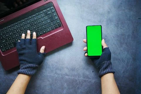Hacker hand stealing data from smart phone Stock Photos